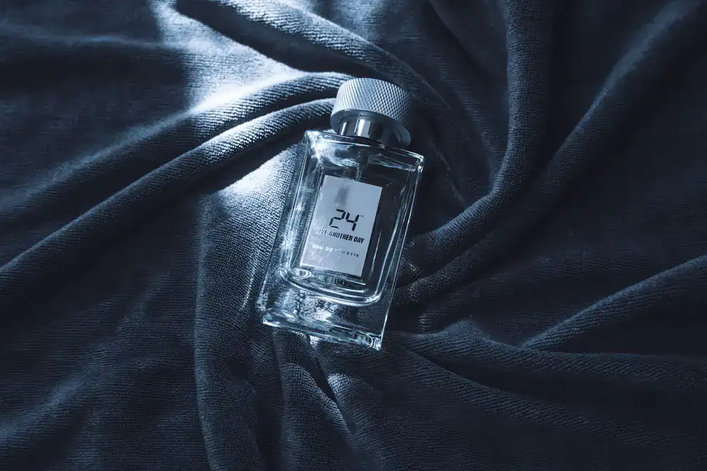 Artisan perfume bottles displayed against a dark textured backdrop
