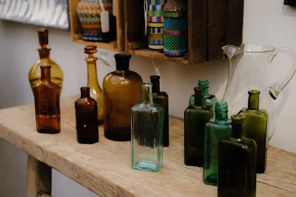 Glass amber bottles aging gracefully on wooden shelves
