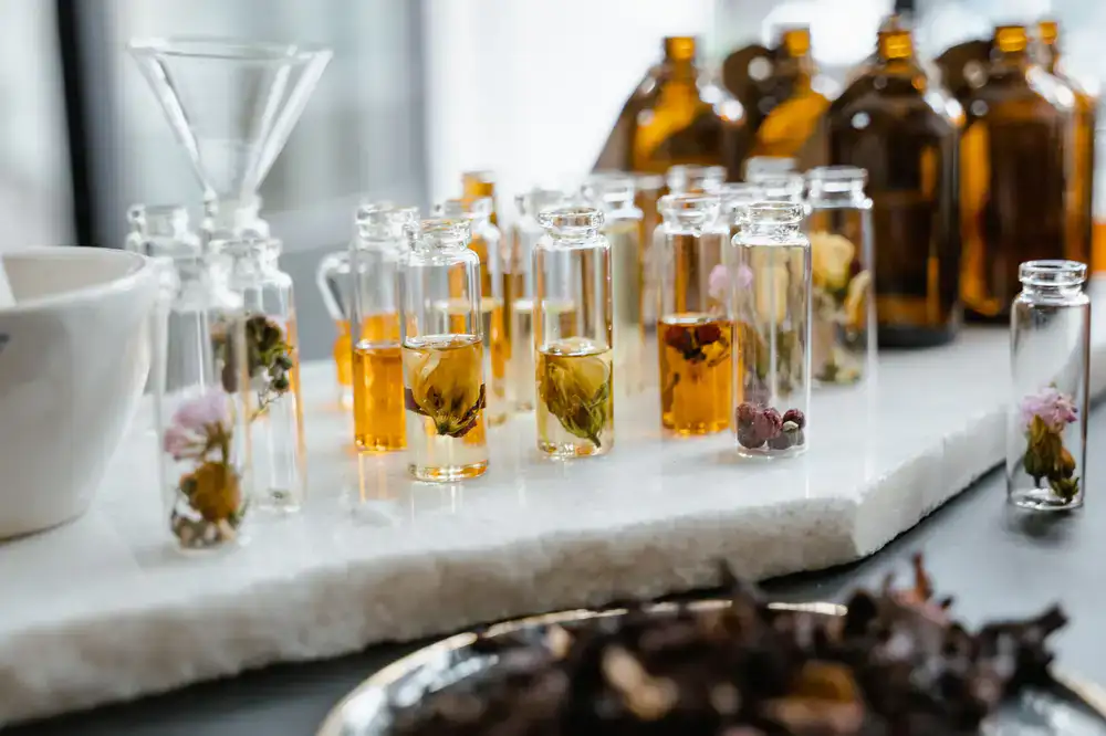A perfume organ showcasing rows of amber glass extract bottles
